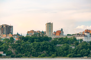View of the city of Khabarovsk from the Amur river. Urban landscape in the evening at sunset.