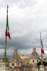 Italian flag in front of roman churches and other buildings