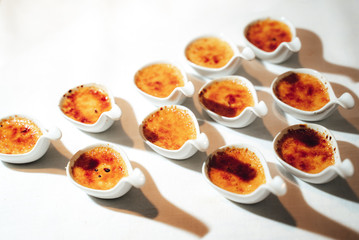 Individual creme brulee desserts in little dishes
