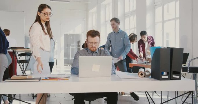 Stressed young businessman suffers panic attack at work, throwing documents up and walking away from office RED EPIC.