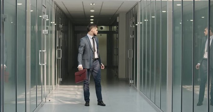 Funny businessman making dance break in office hall, celebrating his victory. Caucasian manager cheering about his achievement - way to success concept 4k