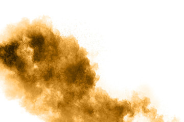 Freeze motion of brown dust explosion. Stopping the movement of brown powder. Explosive brown powder on white background.