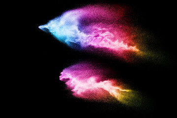 Abstract multicolored sand explosion isolated on black background. Abstract sand cloud. Sandy fly...