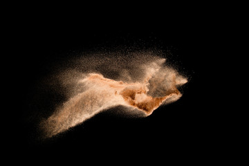 Fototapeta na wymiar Dry river sand explosion isolated on black background. Abstract sand cloud.Brown colored sand splash against dark background.