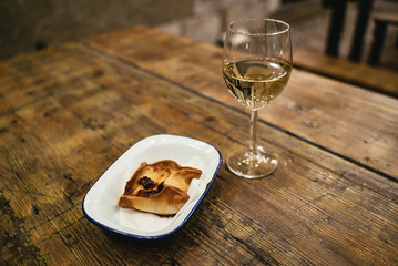 Baked pastry dessert and glass of white wine