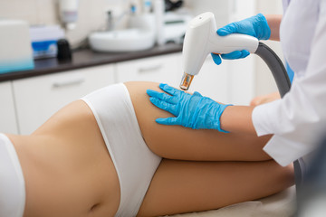 Woman with slim body lying in a beauty salon.