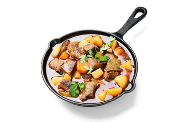 Beef meat  stewed with potatoes, carrots and spices (hungarian goulash). isolated on white...