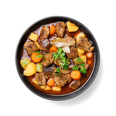 Beef meat  stewed with potatoes, carrots and spices (hungarian goulash). isolated on white...