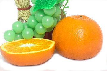 Orange and grape fruit on a white background.