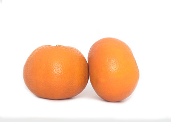 Two mandarin oranges on a white background.