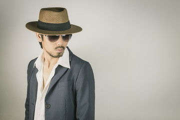 Portrait Man in Navy Blue Suit and Hat and Glasses Turn Back Pose Vintage Tone