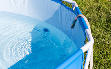 summer garden pool filled with water from a hose