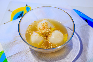 Table is served by plates with chè trôi nước, traditional vietnamese warm dessert.