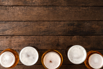 Beer glasses on wooden table with copyspace.