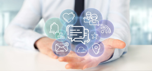 Fototapeta premium Businessman holding a cloud of social media network icon