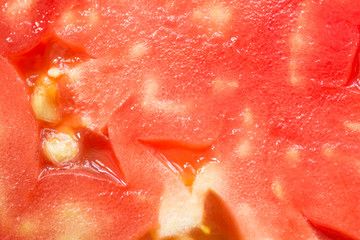 Slice of tomato as background. Detailed close up of Tomato slice - macro tomatoes. 