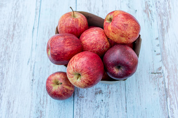 Organic ripe apples in a recyclable paper box on a wooden table. Cooking ingredients. Harvest. Sustainable living. Say “no” to plastic packaging.