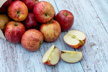 Organic ripe apples on a wooden table. Fresh cut apple healthy snack. Cooking ingredients. Harvest.