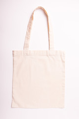 Canvas cotton shopping eco friendly bag over white background. Zero waste, plastic free concept. Top view, flat lay