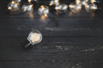 light bulb alone in front of group of other globes, concept of unique ideas