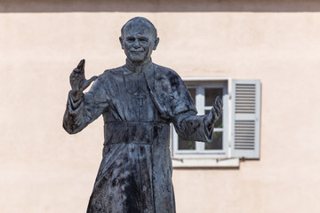 LYON / FRANCE - JULY 2015: Statue of John Paul II pope in front of Notre-Dame de Fourviere Basilica, Lyon, France - obrazy, fototapety, plakaty