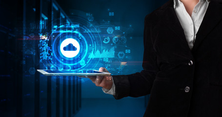 Hand holding tablet with cloud technology and dark concept