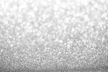 Silver blurred glitter background. Sparkling and shiny texture for Christmas and New Year holiday or seasonal wallpaper decoration