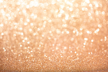 Gold blurred glitter background. Sparkling and shiny texture for Christmas and New Year holiday or seasonal wallpaper decoration