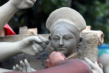 Idol of Hindu Goddess Durga during preparations in Kolkata. Clay idol of Goddess Durga, under...
