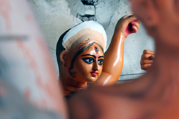 Idol of Hindu Goddess Durga during preparations in Kolkata. Clay idol of Goddess Durga, under...