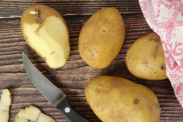 Raw potatoes in the process of peeling