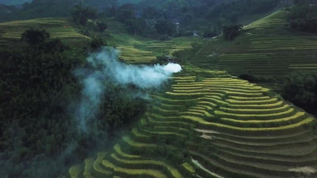 sapa landscape on the evening. Smoke rising from burning rice fields, drone dolly in shot approaching smoke