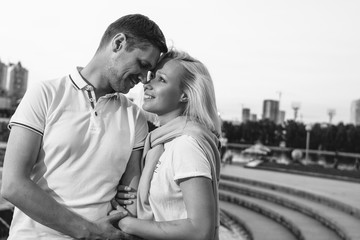 Happy young couple in love  dressed in casual style walking at street