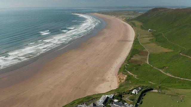 Aerial drone view of the huge, beautiful sandy beach at Rhossili on the Gower peninsula of Wales