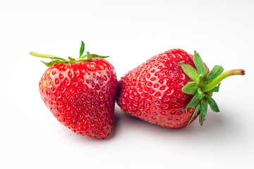 Two strawberries close up on white background