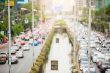 Blurred photo of Sathorn road and traffic in Bangkok. Blur of traffic light on the main road and lighting background.