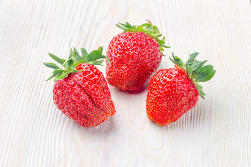 Fresh strawberries on wooden table with high key scene