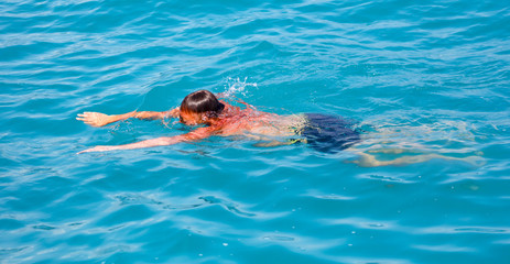 A man swims in the water in the water