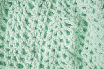 Knitted horizontal mint textured background. Fragment of a mint color children's sweater. Texture, close up. For yarn, children's clothing store, flyer design, banner, for site