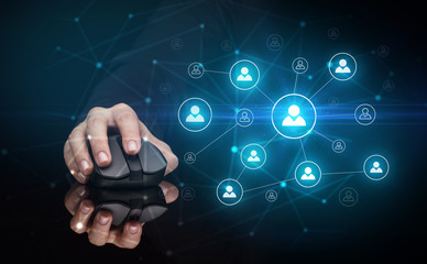Hand using wireless mouse in a dark environment with human network concept