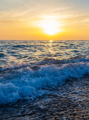 Waves on the seashore at sunset
