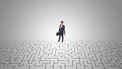 Elegant businessman looking for a solution in a middle of a maze