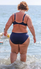 Fat woman by the sea