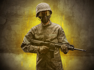 Hazard, menace soldier in a ruined crumbly building with arms on his hand
