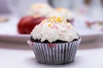 Cake. Cup cake on white table, on white background.