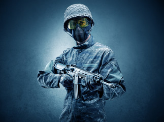 Soldier agent in a dark room with arms on his hand and gas mask