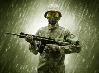 Armed soldier standing in rainy weather