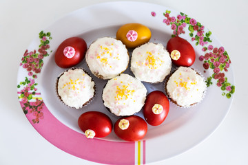 Easter bread cake and painted red eggs on a plate.