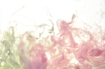 Pink and green acrylic ink in water on white background. Abstract background.
