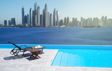 Awesome view of the Dubai Marina from the infinity pool with a deck chair